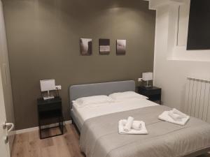 a bedroom with a bed with two towels on it at Fiera City Life 2 Top Apartment in Milan