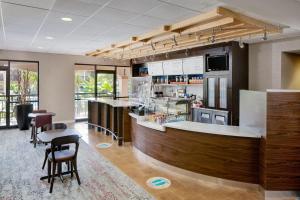 a restaurant with a bar with chairs and tables at Courtyard by Marriott Key West Waterfront in Key West