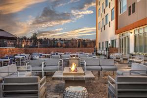 a patio with chairs and a fire pit on a building at Element Knoxville West in Knoxville