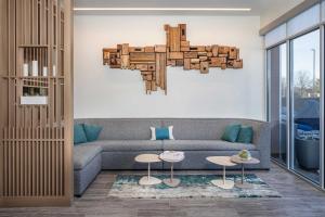 a living room with a couch and a chandelier at Element Knoxville West in Knoxville