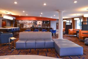 a lobby of a hotel with a bar and chairs at Courtyard Pittsburgh Monroeville in Monroeville