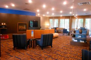 a lobby with a living room with a couch and chairs at Courtyard Pittsburgh Monroeville in Monroeville
