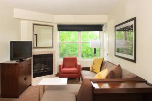 a living room with a couch and a fireplace at Residence Inn Phoenix Mesa in Mesa