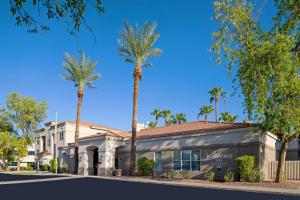 um edifício com palmeiras em frente a uma rua em Residence Inn Phoenix Mesa em Mesa