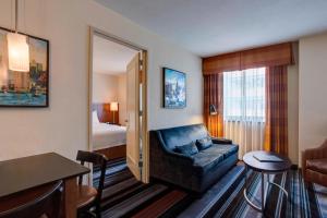 a hotel room with a couch and a bedroom at Residence Inn by Marriott New York Manhattan/Times Square in New York +37 photos