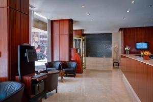 a lobby with chairs and a bar in a building at Residence Inn by Marriott New York Manhattan/Times Square in New York