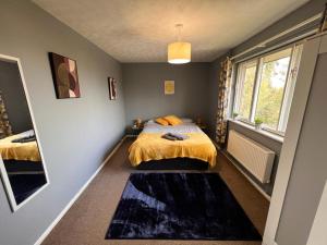 a bedroom with a bed and a window at Spacious Apartment with Parking in Norwich