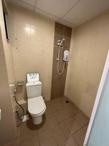a small bathroom with a toilet and a shower at Blest Loft 12 Manhattan Suites ITCC in Penampang