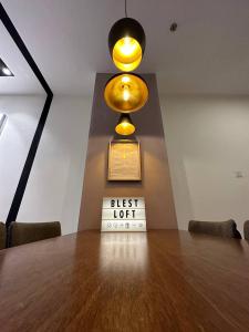 a table in a room with a sign that reads best light at Blest Loft 12 Manhattan Suites ITCC in Penampang