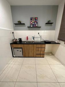 a kitchen with a sink and a counter at Blest Loft 12 Manhattan Suites ITCC in Penampang