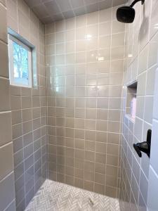 a bathroom with a shower with a tile floor at Citrus Studio A in Chico