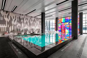 a lobby with a pool and a stained glass window at Toronto Marriott Markham in Markham