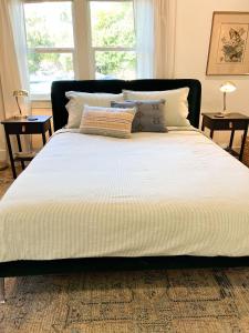 a bed with white sheets and pillows in a bedroom at Citrus Studio A in Chico