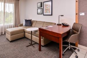 a living room with a couch and a desk at Residence Inn by Marriott Florence in Florence