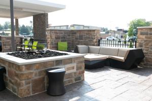 a patio with a couch and a fire pit at SpringHill Suites by Marriott South Bend Notre Dame Area in South Bend
