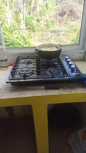 a pan on top of a stove in a kitchen at Hotel i t a in Las Galeras