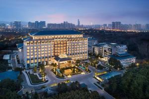 an aerial view of a large building with a city at Wuxi Marriott Hotel Lihu Lake in Wuxi