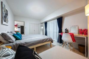a bedroom with two beds and a desk and a chair at Asakusa 2 Bedroom Apartment 西浅草2LDK広々ファミリーorグループ in Tokyo