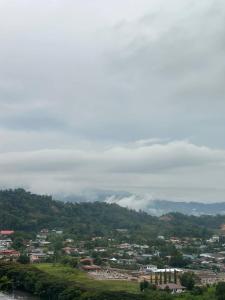 a town on a hill with clouds in the background at Blest Loft 7 Manhattan Suites ITCC in Penampang