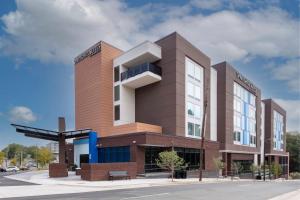 a building on a street with a sky at SpringHill Suites By Marriott Durham City View in Durham