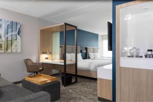 a hotel room with a bed and a desk at SpringHill Suites By Marriott Durham City View in Durham +19 photos