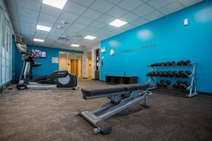einen Fitnessraum mit Trainingsgeräten und einer blauen Wand in der Unterkunft Fairfield Inn & Suites By Marriott Alexandria in Alexandria