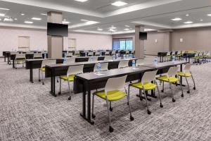 a large room with tables and chairs in a classroom at SpringHill Suites By Marriott Durham City View in Durham