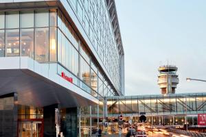a view of a building with a control tower in the background at Marriott Montreal Airport In-Terminal Hotel in Dorval