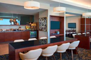 a conference room with a table and white chairs at Marriott Montreal Airport In-Terminal Hotel in Dorval
