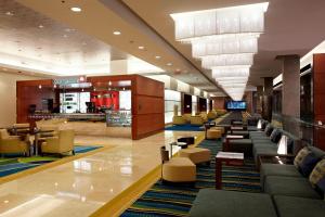 a lobby with couches and chairs in a mall at Marriott Montreal Airport In-Terminal Hotel in Dorval
