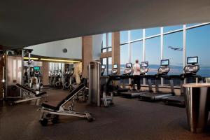 a gym with a view of the ocean in a building at Marriott Montreal Airport In-Terminal Hotel in Dorval