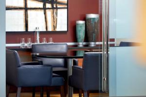 a dining room with blue chairs and a table at Marriott Montreal Airport In-Terminal Hotel in Dorval