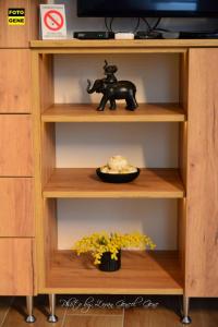 a shelf with a toy elephant and a plate of food at Apartment No 11 in Subotica