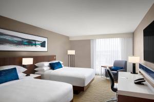 a hotel room with two beds and a tv at Delta Hotels by Marriott Thunder Bay in Thunder Bay