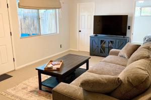 a living room with a couch and a coffee table at Elden House - Perfect Mountain Escape for Groups & Families! in Flagstaff