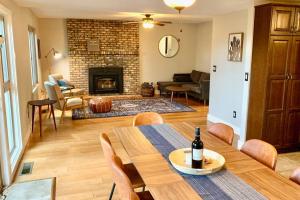 a living room with a table and a fireplace at Elden House - Perfect Mountain Escape for Groups & Families! in Flagstaff