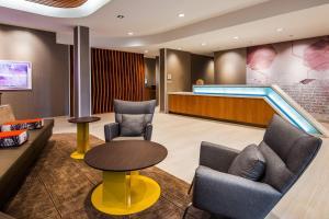 a waiting room with chairs and a pool at SpringHill Suites by Marriott Chambersburg in Chambersburg