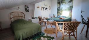 a room with a bed and a table and chairs at Ker Isari in Auterive