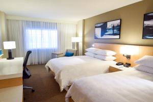 a hotel room with two beds and a window at Delta Hotels by Marriott Little Rock West in Little Rock