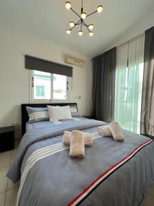 a bedroom with a large bed with two towels on it at Three Bedroom Casa de Paphos in Paphos City
