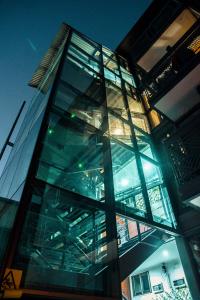 a glass facade of a building at night at Bella 269 in Santiago