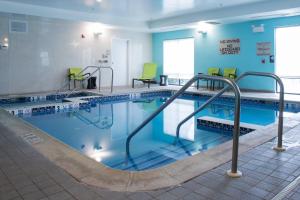 una gran piscina con sillas y mesas en un edificio en SpringHill Suites Quakertown Pennsylvania, en Quakertown