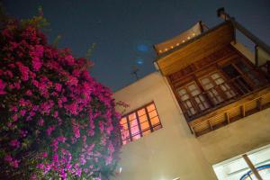 a building with pink flowers in front of a building at Bella 269 in Santiago