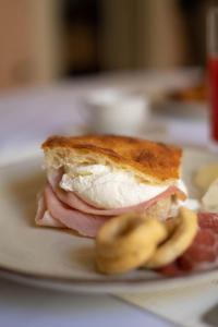 a sandwich on a plate with some meat and bananas at Palazzo Zacà in Gallipoli
