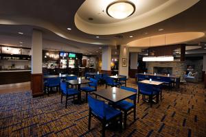 a restaurant with tables and chairs and a bar at Courtyard by Marriott Halifax Downtown in Halifax