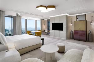 a hotel room with a bed and a living room at Josun Palace, a Luxury Collection Hotel, Seoul Gangnam in Seoul