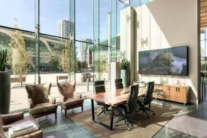 a conference room with a table and chairs and a large window at Civic Hotel, Autograph Collection in Surrey