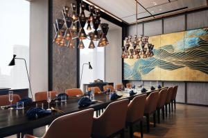 a long dining room with a long table and chairs at mesm Tokyo, Autograph Collection in Tokyo