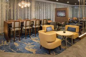un restaurante con un bar con mesas y sillas en Marriott Tampa Westshore, en Tampa