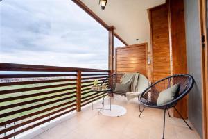 a balcony with two chairs and a table at Peaceful Condo w/ Amazing View in Bansko